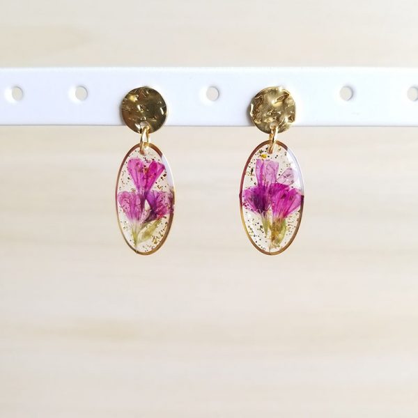 Add a vibrant splash of color and a little glitter to your outfit with these dried pink flower petal earrings.