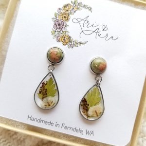 Bring your garden indoors with these one of a kind dried flower resin earrings featuring unakite gemstones.