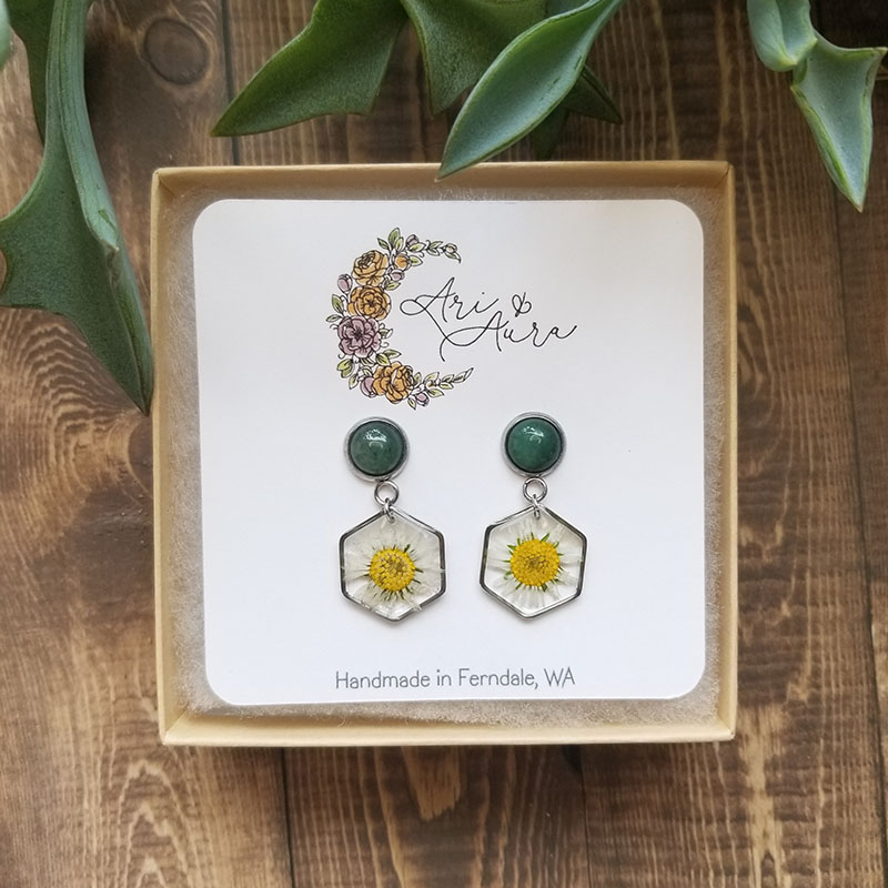 Intended to bring joy and healing the daisy flower is one of the first to open to the sun each morning. These pressed daisy flower resin earrings will surely bring a smile to your face.