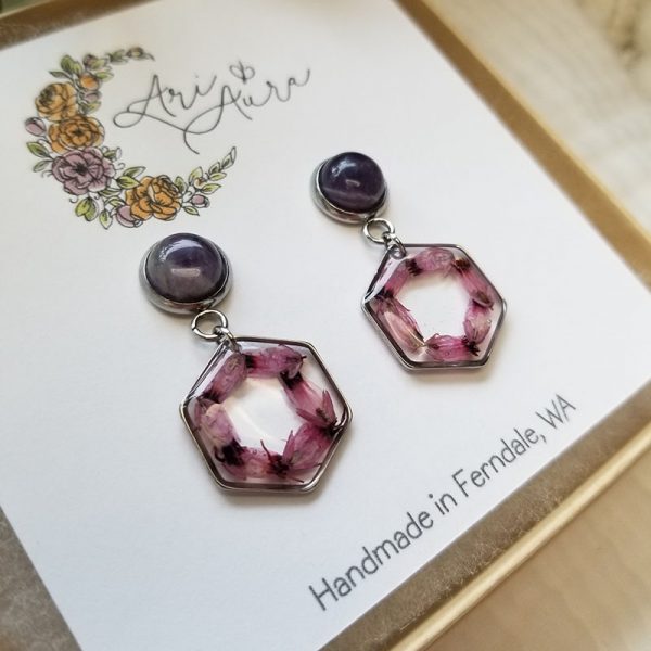 These magical dried flower wreath dangle earrings are made by delicately placing small pressed flowers inside an open bezel and encasing with resin.