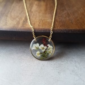 These wildflowers are hand-picked on my walks through nature. They are then pressed and made into a high quality resin necklace with intention to bring a love of nature into our everyday attire.