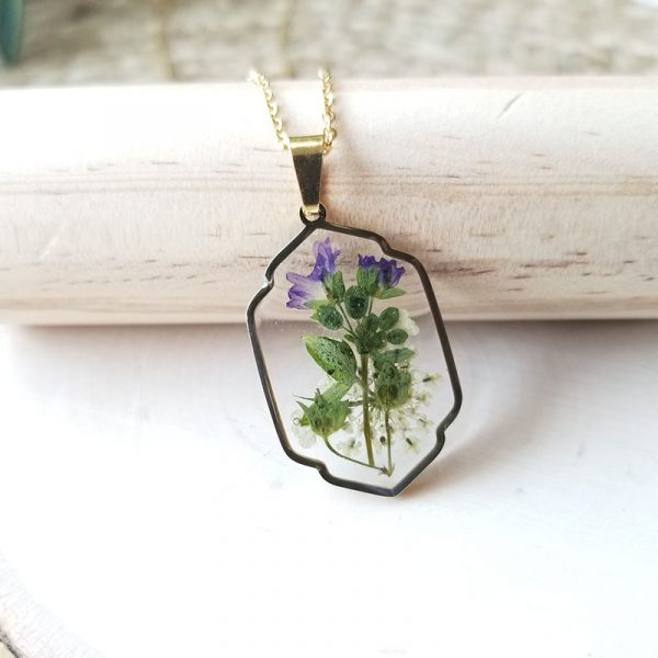 Add a touch of whimsy to your wardrobe with this unique one of a kind dried pressed wildflower resin necklace that has been made with high quality resin.