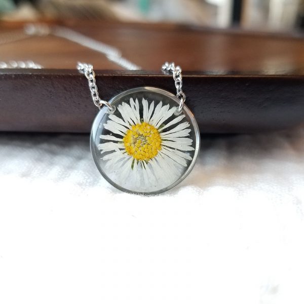 Intended to bring joy and healing the daisy flower is one of the first to open to the sun each morning. This pressed daisy flower resin necklace will surely bring a smile to your face.