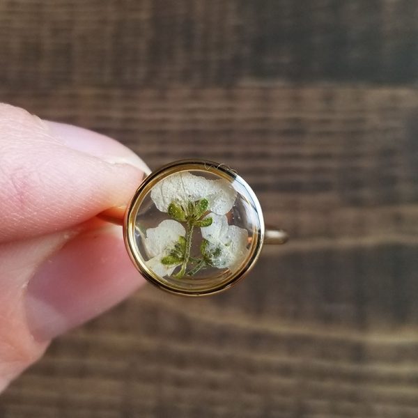 This Dried Alyssum flower resin gold ring was inspired by the natural beauty of the Pacific Northwest and the flowers that grow there, making it the perfect gift for the one who loves the outdoors.