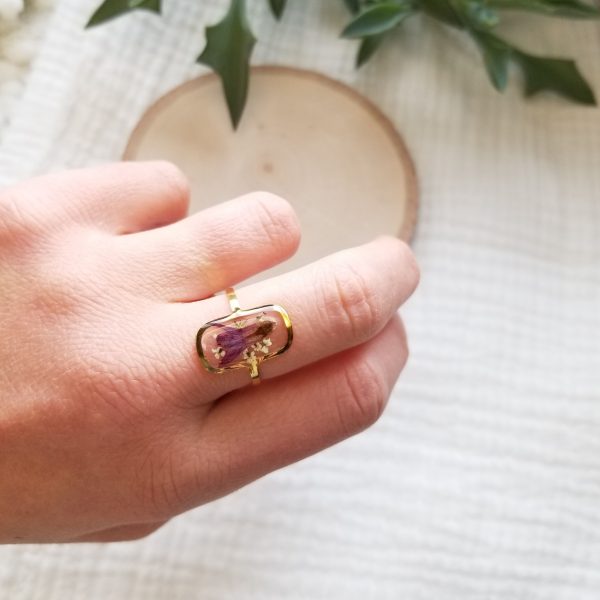 Add a touch of nature to your wardrobe with this one of a kind dried wildflower resin ring.