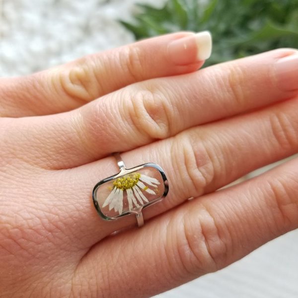 This one of a kind, handcrafted dried daisy flower resin ring is adjustable making it an easy fit for anyone.