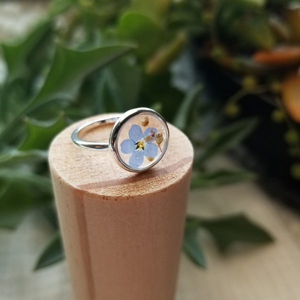 Add a splash of blue to your accessories collection with this one of a kind hand dried forget me not flower silver resin ring.