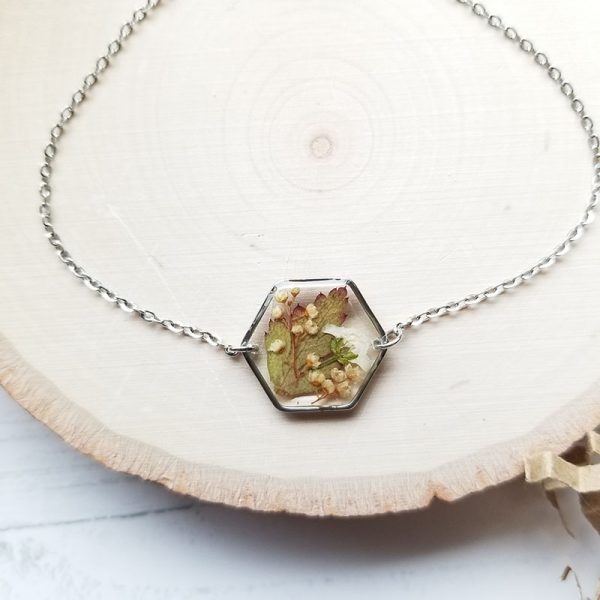Take a little piece of nature with you wherever you go with this one of a kind tiny dried fern and wildflower resin bracelet!