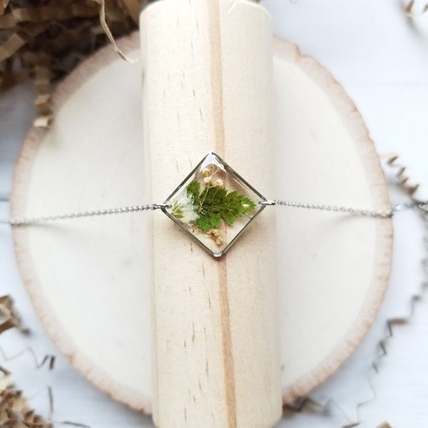 Take a little piece of nature with you wherever you go with this one of a kind tiny dried fern and wildflower resin bracelet!