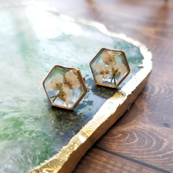 Add a touch of whimsy to your accessory collection with these dried flower stud earrings made of high quality resin.